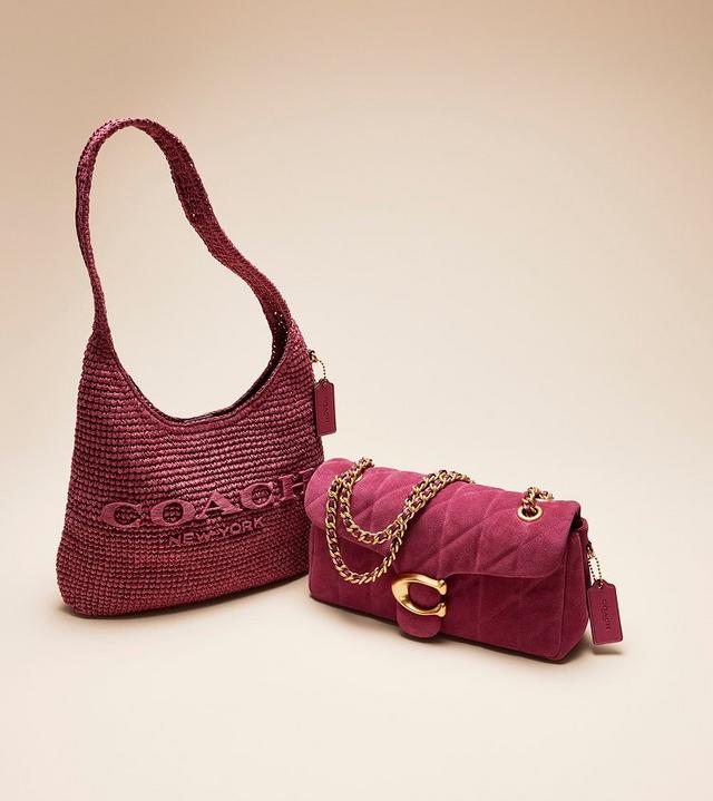 two purses, one pink and one brown, sitting next to each other