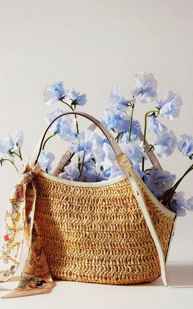 a bag with flowers in it sitting on a table