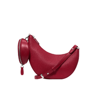 Red leather hobo bag with matching round coin purse attached to strap.