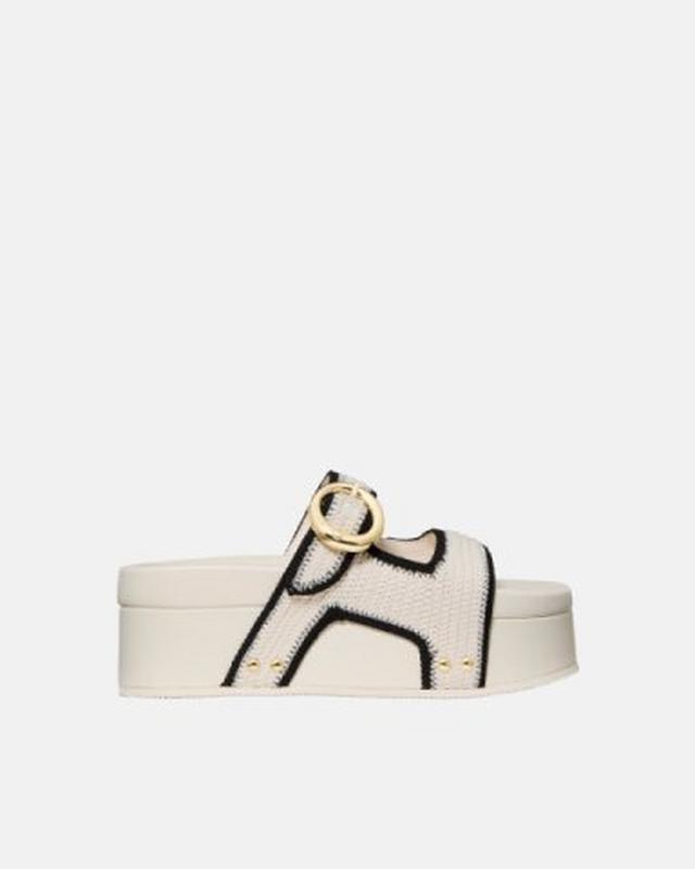 Cream platform slide sandal with black outlined H-shaped cutout design and gold ring hardware detail.