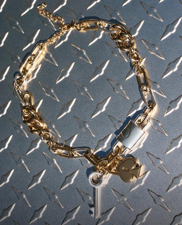 Gold-tone chain necklace with mixed link styles and a padlock pendant with key attached.
