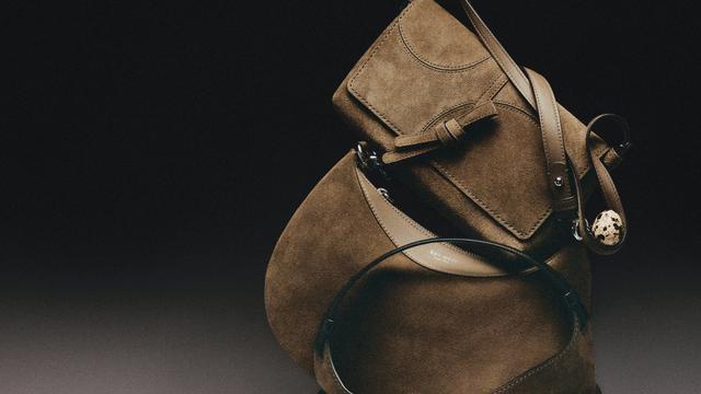 Tan suede ankle boots with block heels and buckle straps, displayed on their side.