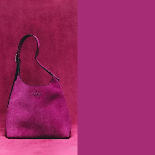 Kate Spade New York magenta suede hobo shoulder bag with adjustable strap.