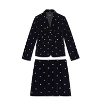 Black polka dot blazer and skirt set with white dots throughout both pieces.