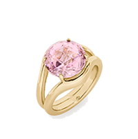 Gold ring featuring a large oval pink gemstone in a prong setting with a split band design.