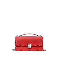 Red leather crossbody bag with pyramid stud closure and top handle.