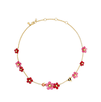 Gold-tone necklace with pink and red flower charms and crystal accents.