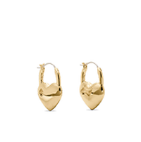 Gold hoop earrings with heart-shaped charms dangling from each hoop.