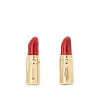 Two red lipsticks in gold tubes with decorative embellishments, standing upright side by side.