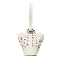 White decorative candle holder with star-shaped cutouts and a cream pillar candle inserted.
