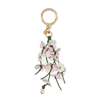 Pink fabric tassel keychain with gold-tone hardware and decorative pearl-like beads.