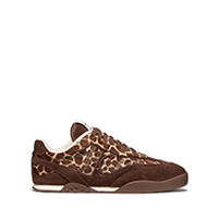 Brown suede sneaker with decorative studded detailing on the upper and white sole.