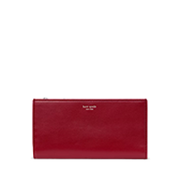 Red Kate Spade leather wallet with gold logo and snap closure.
